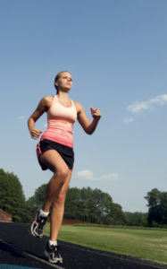 Young woman demonstrates good running posture