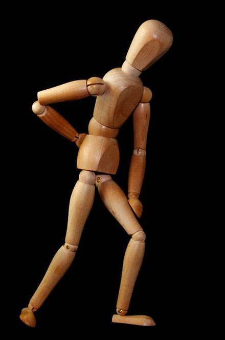 wooden figure with lower back pain