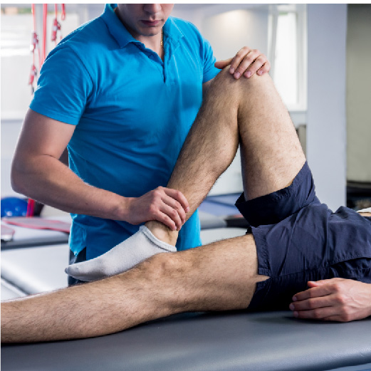 Physiotherapist working on a man's leg